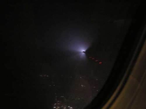 cool shot of the wing light over the city lights